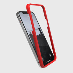 A red iPhone 13 Screen Protector - Full Coverage case with a tempered glass screen protector on a white background, made by Raptic.