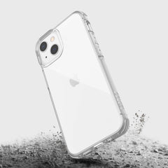 A Raptic iPhone 13 Mini Case - CLEAR with sand on it.