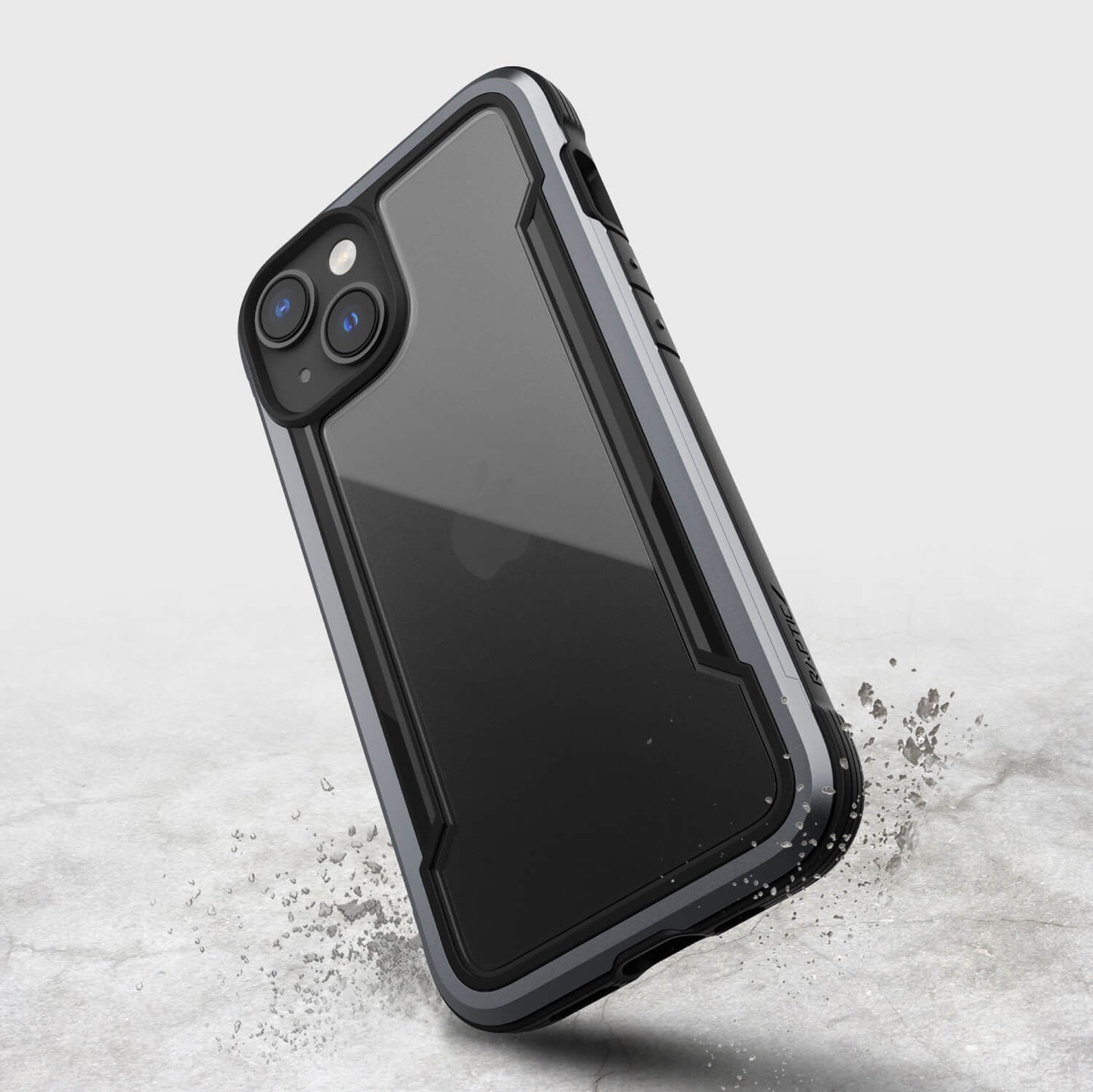 The Raptic iPhone 14 Case - Shield is displayed on a concrete surface, offering screen protection.