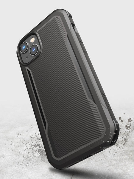 A biodegradable black Raptic iPhone 14 Plus Case - Fort Built for MagSafe with a splash of water on it, providing military-grade drop protection.