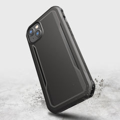 A biodegradable black Raptic iPhone 14 Plus Case - Fort Built for MagSafe with a splash of water on it, providing military-grade drop protection.