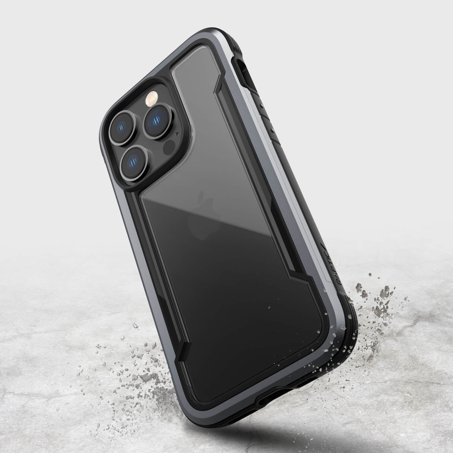 The Raptic iPhone 14 Pro case - Shield is displayed on a concrete surface, featuring MagSafe compatibility.