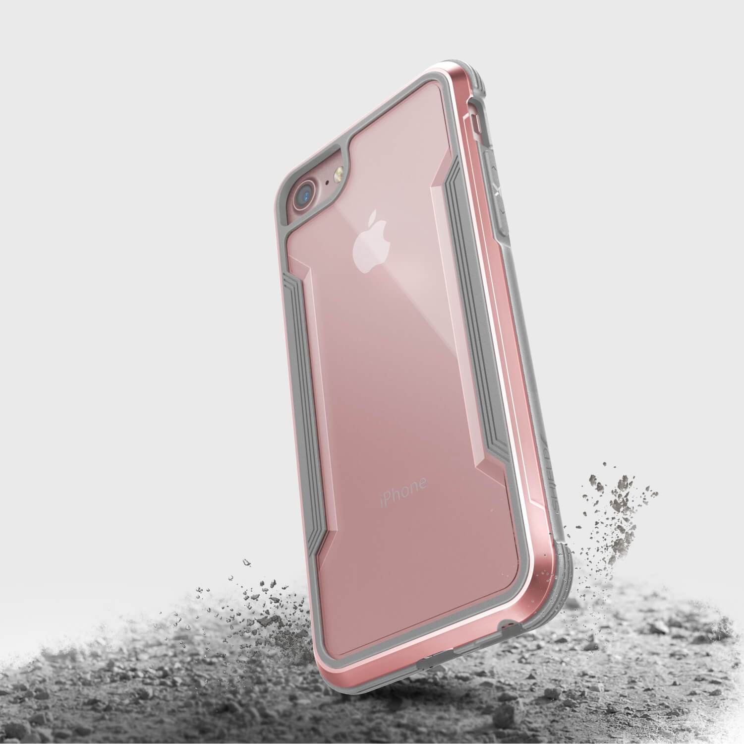 A pink and silver SHIELD iPhone SE/8/7 case from Raptic on the ground.