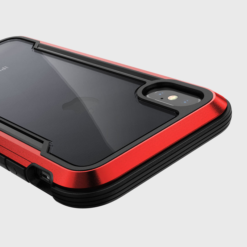 The Raptic SHIELD case for iPhone X/XS, featuring a sleek red design and clear back, not only highlights the rear camera and flash but also provides military-grade drop protection.