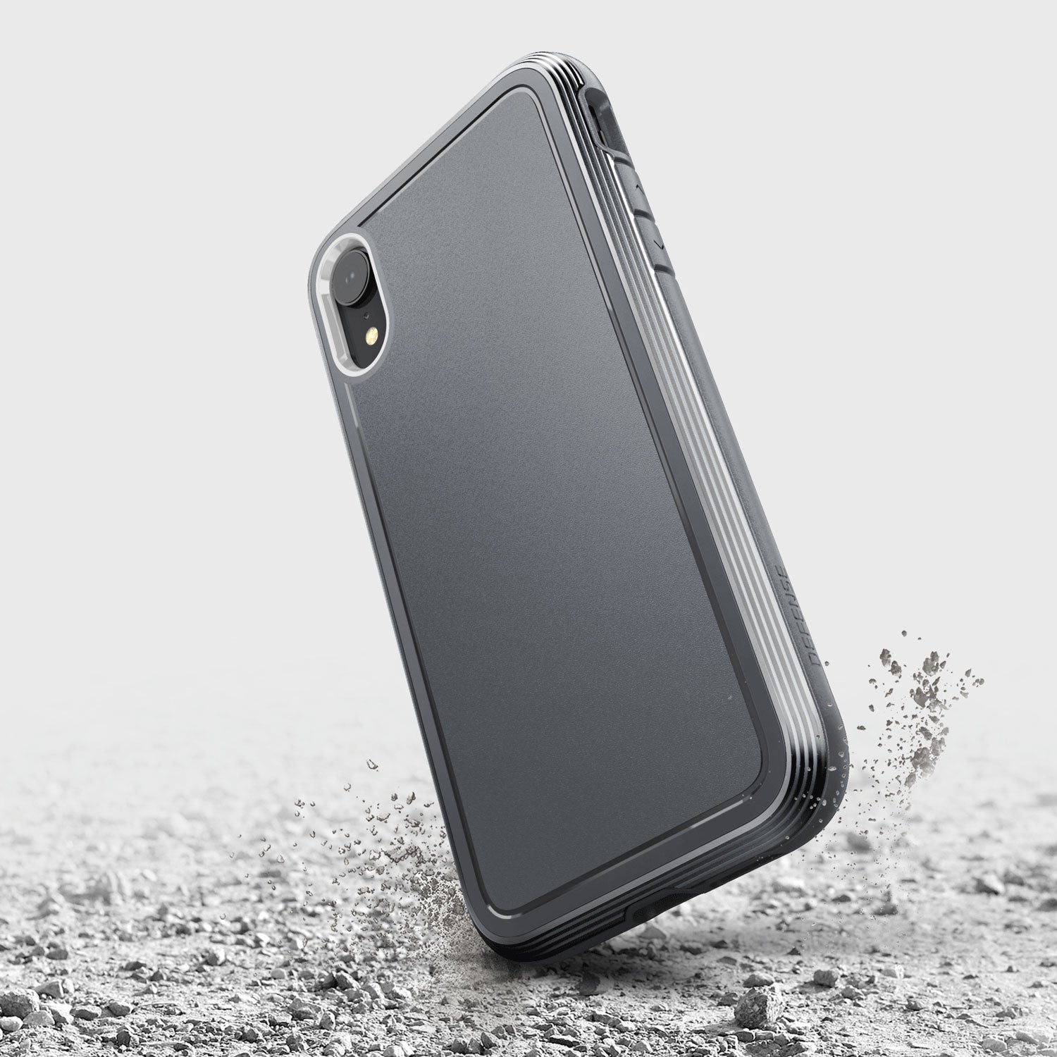 The back of an iPhone XR case, specifically the Raptic ULTRA case, is seen lying on the ground.