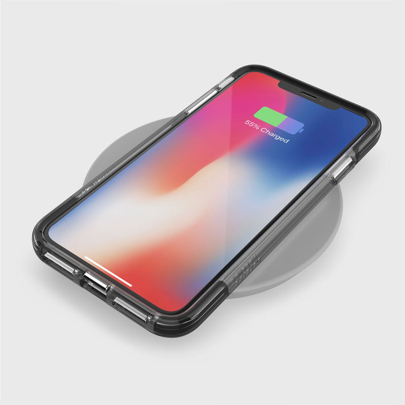 A smartphone with a clear Raptic iPhone XS Max case is on a wireless charger. The screen shows a 55% charged battery icon, and the military-grade drop protection keeps it safe.