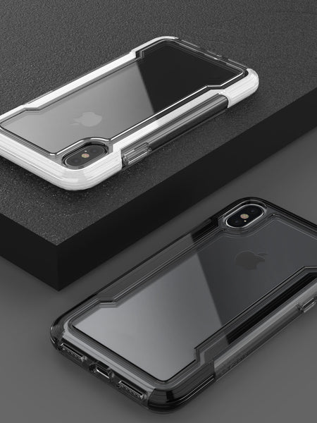Two iPhones with transparent Raptic cases are showcased on a dark surface, highlighting the camera placements and brand logos. These CLEAR iPhone X/XS cases provide anti-yellow, anti-scratch backing for visibility and military-grade drop protection for peace of mind.