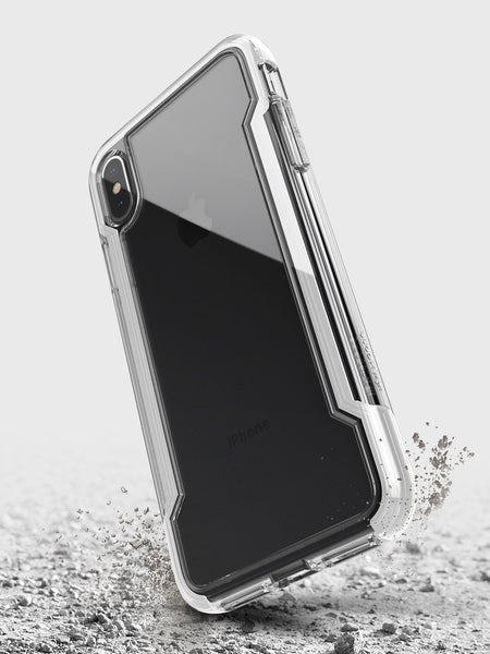 The Raptic iPhone XS Max Case - CLEAR, featuring transparent, anti-yellow, and anti-scratch protection, appears suspended above a cracked surface to demonstrate its military-grade drop protection.