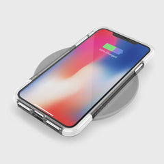 The iPhone XS Max is protected by a Raptic CLEAR case with military-grade drop protection, anti-yellow, and anti-scratch features, and sits on a wireless charging pad displaying 55% battery charged.