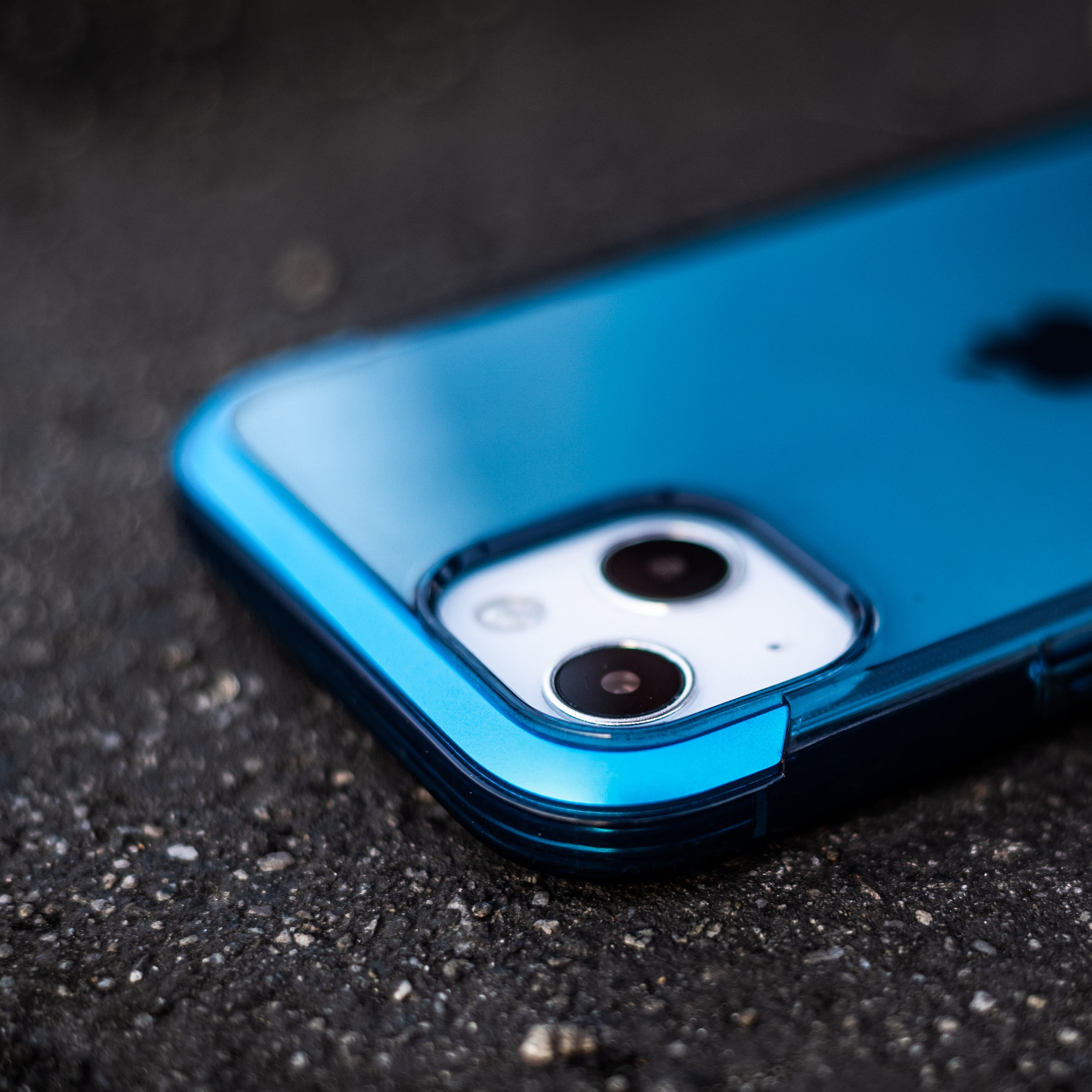 A blue Raptic iPhone 13 Pro Case - AIR with two cameras that is wireless charging compatible.