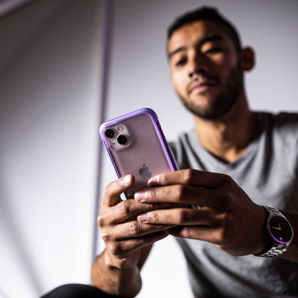 A man is holding a Raptic eco-friendly iPhone 13 Case - TERRAIN.